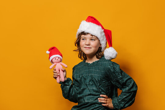 Girl standing with crochet toy on Christmas eve