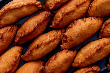 Close-up of the closely arranged panzerotti, a famous Italian deep-fried dish horizontal image