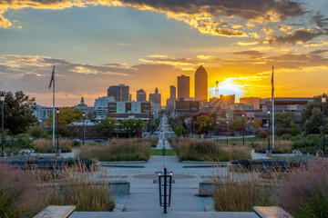 View of the downtown Des Moines skyline from the steps of the Iowa State Capitol Building at sunset.
