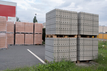 Pallet of Concrete Cinder Blocks, Grey Uniformed brick Shapes building material. New for use on construction site