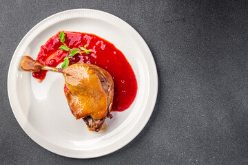 duck leg confit berry sauce second course healthy meal food snack diet on the table copy space food background rustic top view