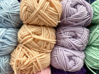 Rainbow colors. Yarn for knitting. Skeins of yarn. Knitting needles, colorful threads. Knitting background