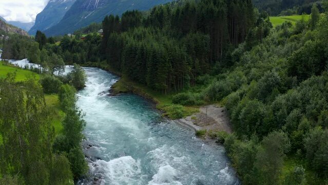 Lake bottom Loenvatnet with glacial river starting to flow dowm Lodalen valley - moving aerial