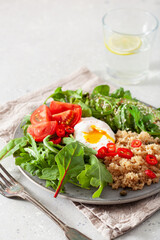 quinoa with poached egg, avocado tomato salad leaves. healthy vegetarian lunch breakfast