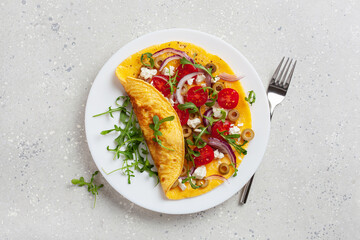 omelette with tomato, feta cheese onion and arugula. healthy keto diet low carb breakfast