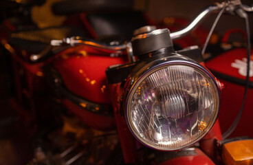 Close up shot of a vintage motorcycle headlight.