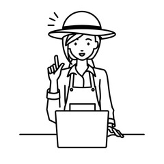 デスクで座ってPCを開いて何かひらめいた農家の女性