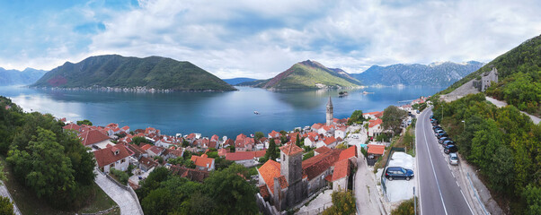 Aerial  view of the historic town of Perast at Bay of Kotor. View over roofs to the campanile of the Church of St. Nicholas and  islands St. George and Our Lady of the Rocks. Perast, Montenegro