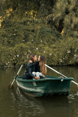 Fototapeta na wymiar Young couple in a romantic boat ride