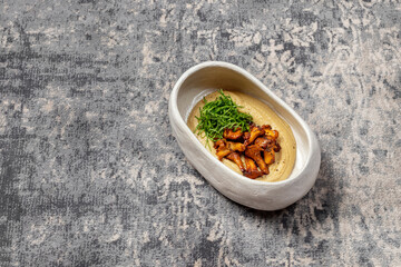 Hummus with fried chanterelle mushrooms.