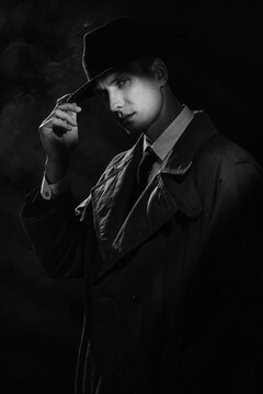 a dark silhouette of a man in a raincoat and a hat in the style of crime noir. A dramatic noir portrait in the style of detectives of the 1950s.
