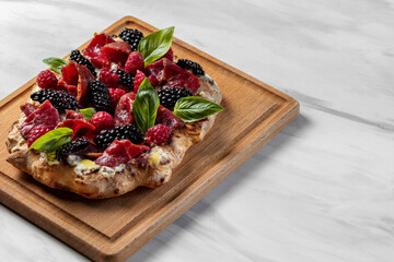Pinza with berries and prosciutto