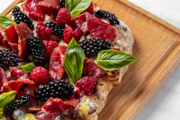 Pinza with berries and prosciutto