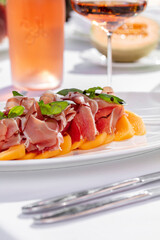 Salad with melon and prosciutto with a bottle of wine
