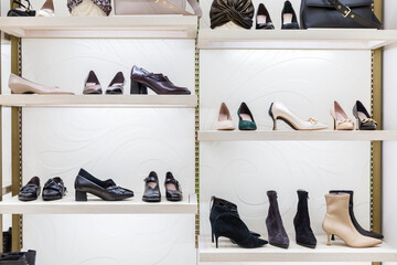 Elegant women's shoes on the shelves in a boutique. Shoes, boots and boots. Fashion & Style. Front...