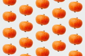 Trendy pattern with orange decorative pumpkins on white background top view. Creative autumn, halloween or thanksgiving concept