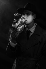 Dark noir portrait of a male detective smoking a retro smoking pipe with tobacco. Private...