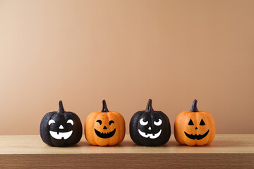 Halloween holiday concept with jack o lantern glitter orange and black pumpkin decoration on wooden...