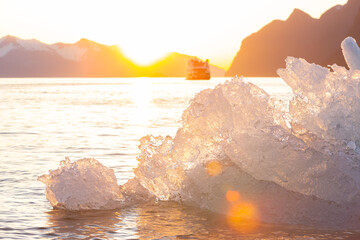 Ice Berg floating in LeConte Bay backlight by the setting sun