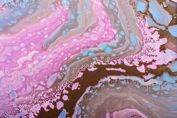 Fluid acrylic painting in pink and gold colors