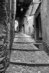 Obraz premium Old narrow alley in the city centre of Castel Vittorio; It's a small village of far west of Liguria Region (Northern Italy), near the French borders.