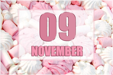 calendar date on the background of white and pink marshmallows. November 9 is the ninth day of the...