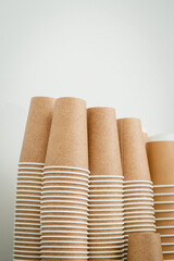 stacks of craft coffee cups for takeaway. Bio degradable tableware.