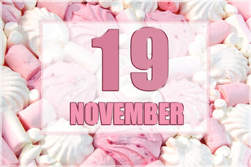 calendar date on the background of white and pink marshmallows. November 19 is the twenty-second day of the month