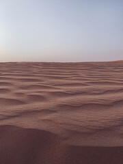 Dune in desert against a sky