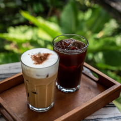 Coffee latte and americano with ice on a wooden tray ready to serve