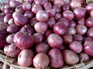 Red onions in the basket, healthy organic food, vegetables. Autumn harvest, farmers market stall, natural texture.