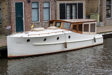 boat on the river with old house in the background