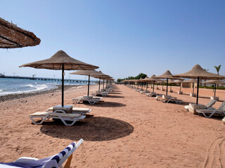 beach with awnings for shade and sun loungers