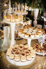 Festive candy bar on the served table at the wedding banquet.