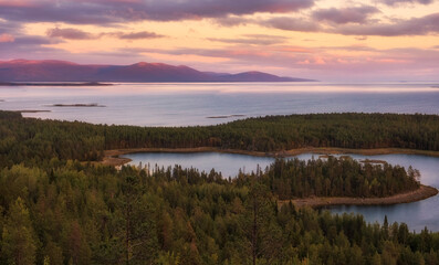 view on north white sea from the rock with forest on sunset. Autumn evening landscape in north