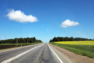 Asphalt road going over the horizon on a sunny day