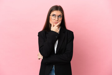 Young Business caucasian woman isolated on pink background having doubts