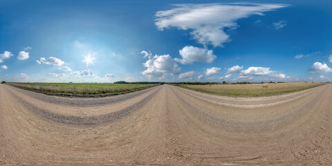 Fototapeta na wymiar full seamless spherical hdri 360 panorama view on no traffic gravel road among fields with overcast sky and white clouds in equirectangular projection,can be used as replacement for sky in panoramas