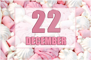calendar date on the background of white and pink marshmallows. December 22 is the twenty-second day of the month
