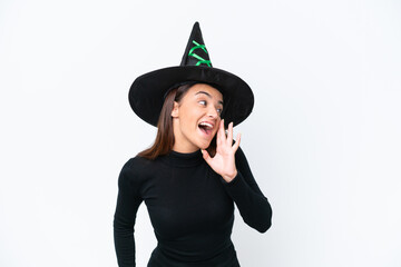 Young caucasian woman costume as witch isolated on white background shouting with mouth wide open to the lateral