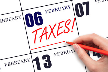 Hand drawing red line and writing the text Taxes on calendar date February 6. Remind date of tax payment