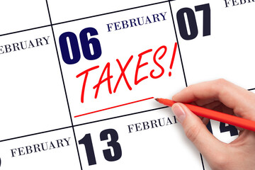 Hand drawing red line and writing the text Taxes on calendar date February 6. Remind date of tax...