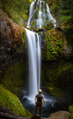 Falls Creek Falls waterfalls with man in foreground. 