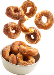 Homemade donuts falling into a bowl