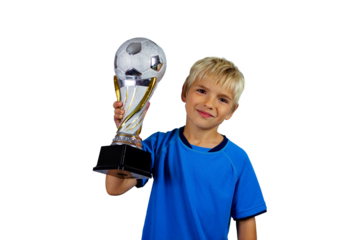 Young soccer player in blue jersey holds winners cup after the goal, isolated at light background