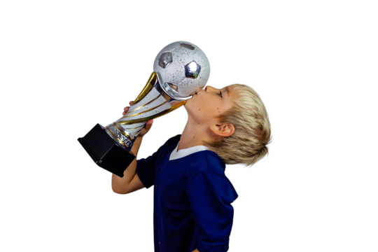 Young soccer player in blue jersey holds winners cup after the goal, isolated at light background
