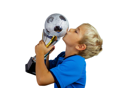 Young soccer player in blue jersey holds winners cup after the goal, isolated at light background