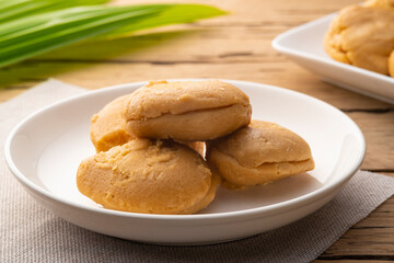 Natural Coconut palm sugar in white dish.Sweet condiment for Thai Traditional food.