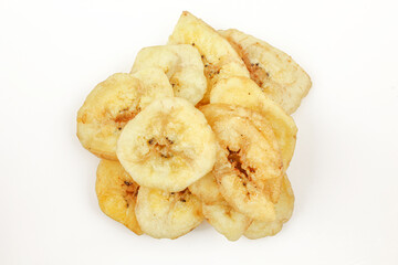 Pile of dried and sliced healthy banana snack isolated on white background