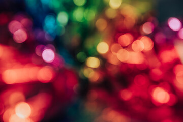Fototapeta premium Blurred bokeh background for Christmas and New Year holiday. Abstract colorful wallpaper with defocused lights. Copy space
